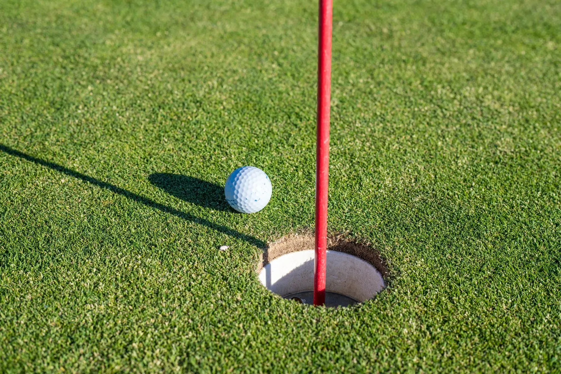A golf ball finishing close to the hole