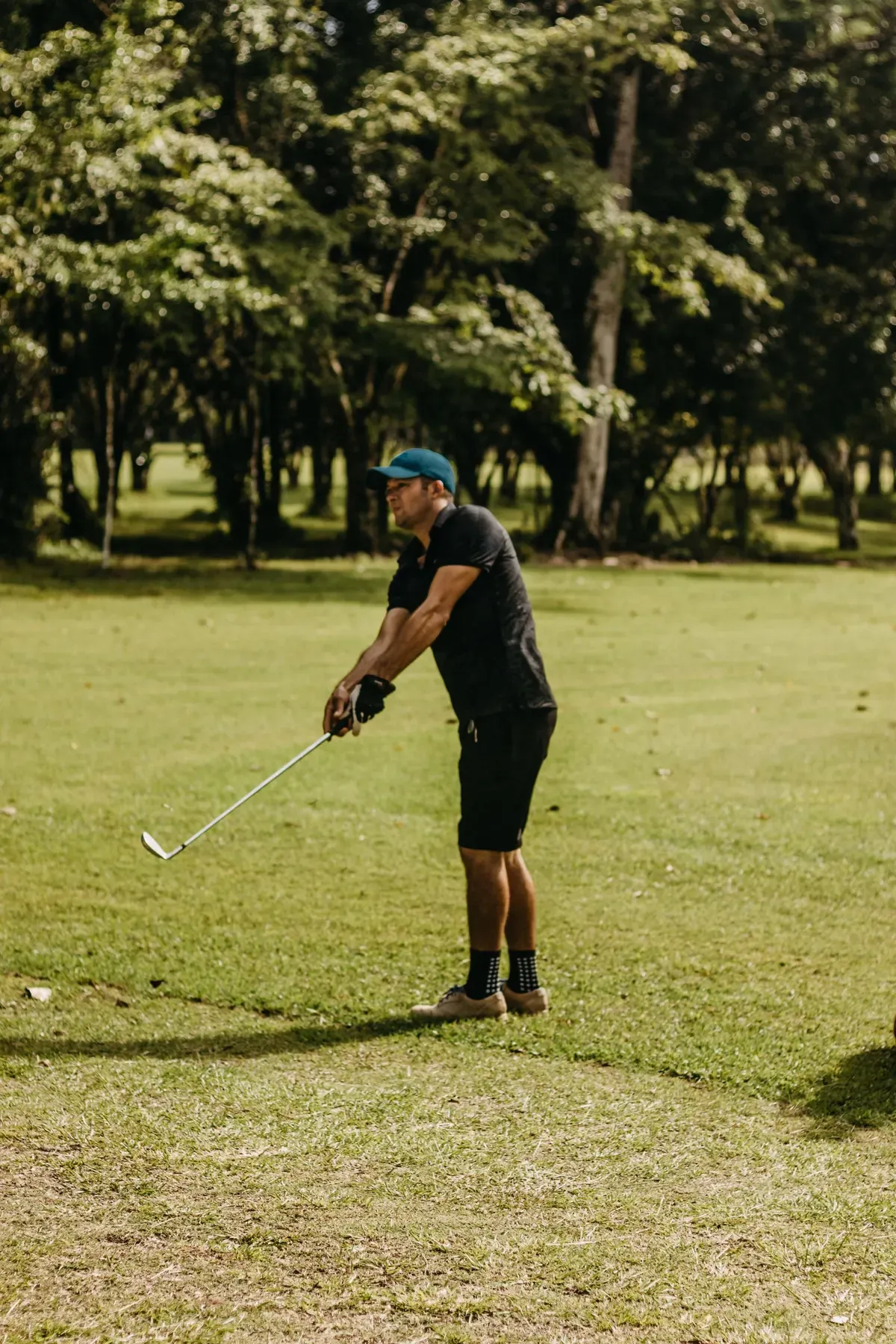 A golfer preparing to play an iron shot